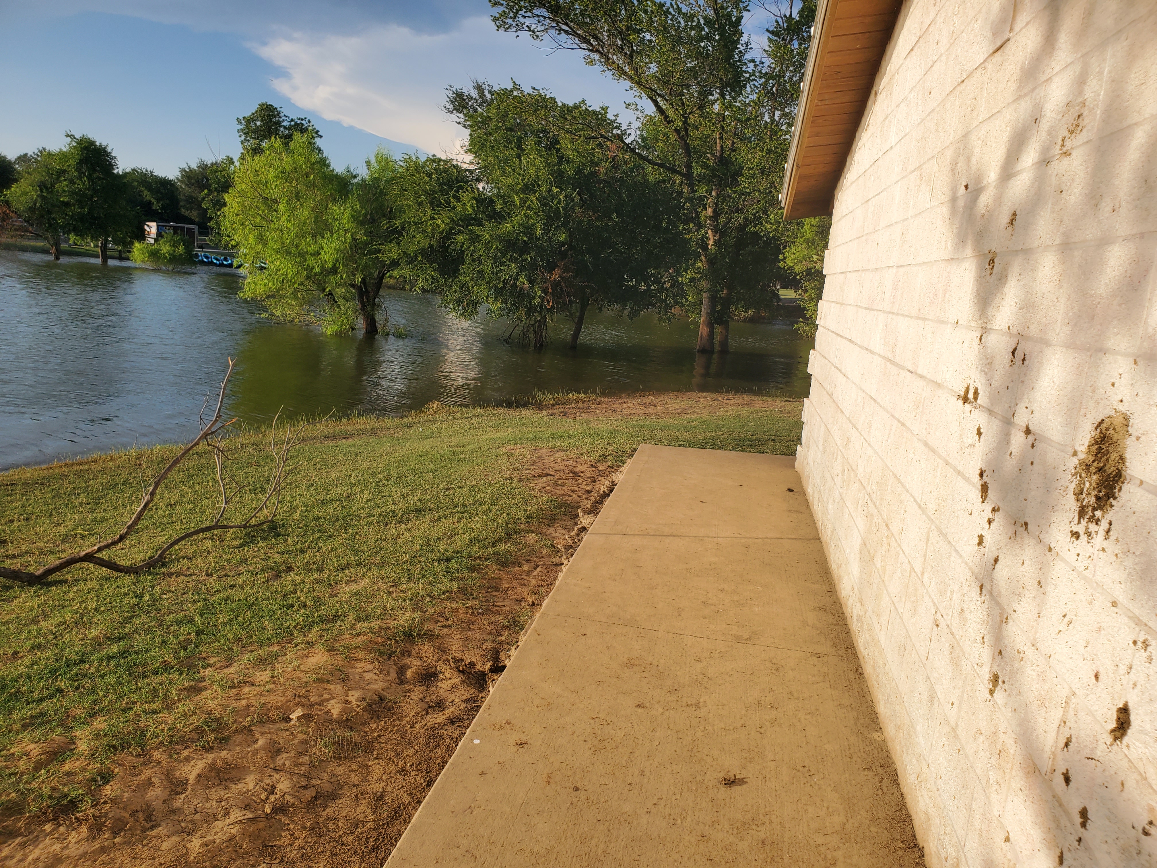 The water catches up to a nearby building. Lucky that place won't be getting wet.